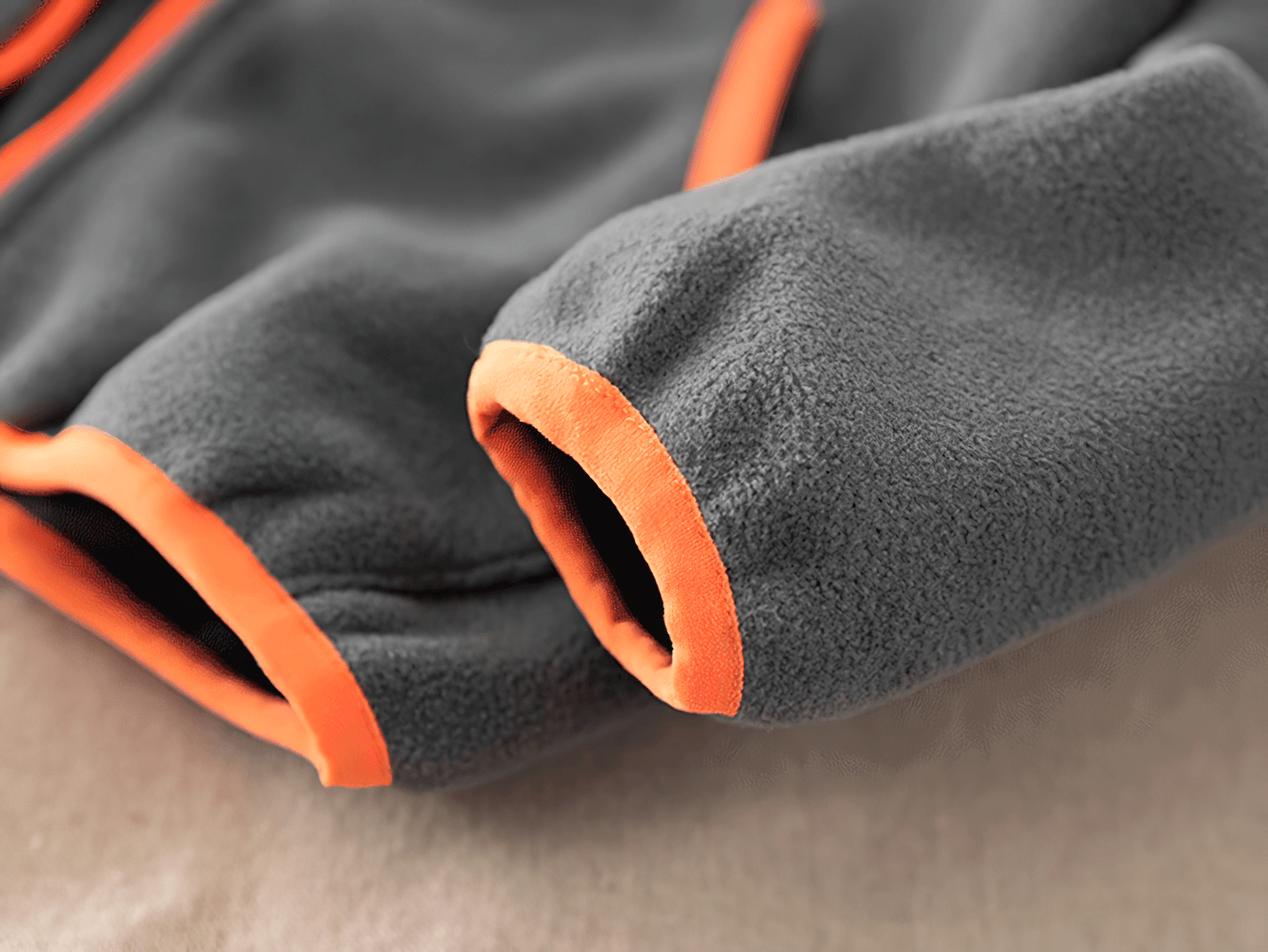 Close-up of a Windproof Fleece Hooded Zip Jacket for Kids - SF3551, showcasing the fleece fabric and contrast orange zipper details.
