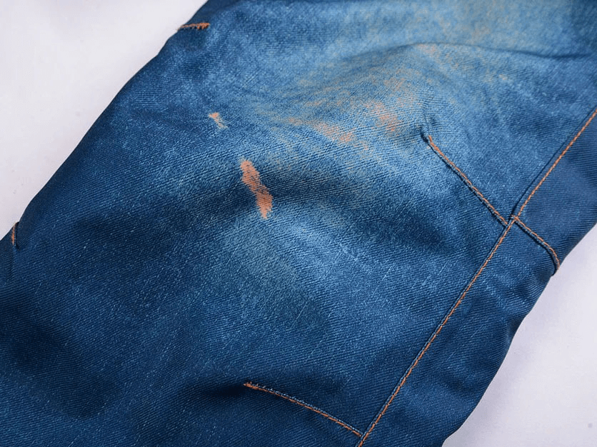 Close-up of windproof thermal snowboard denim pants with stitch detailing, perfect for skiing and cold weather.