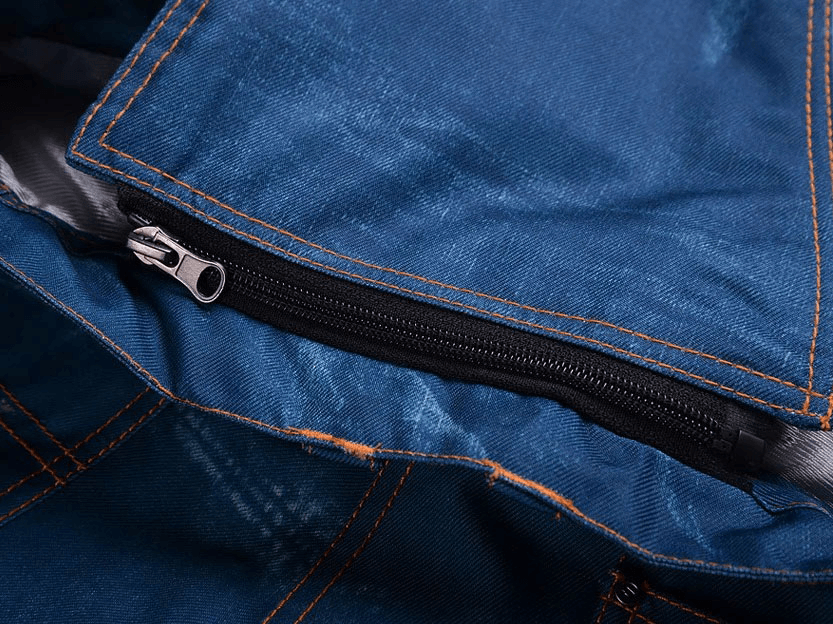 Close-up of windproof snowboarding denim pants showcasing zipper fly closure, designed for warmth and a secure fit.