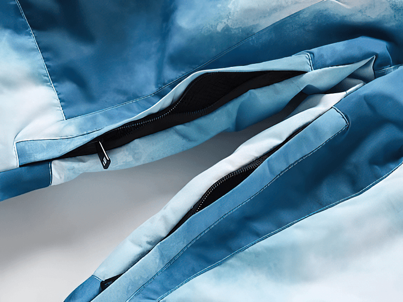 Close-up of blue windproof ski trousers with zipper detail on leg, part of SF1820 collection for skiing and snowboarding.
