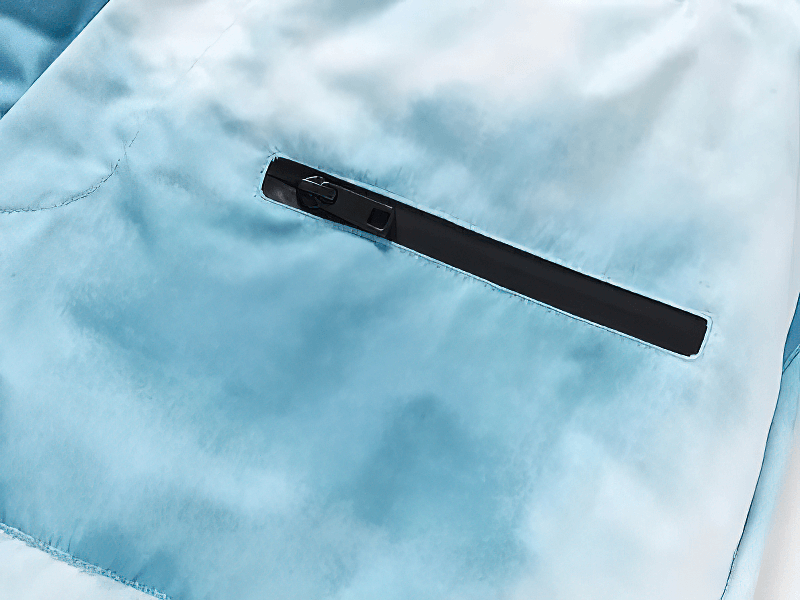 Close-up of pocket on windproof warm big ski trousers in blue, showing durable fabric and sleek zipper detail for style and function.