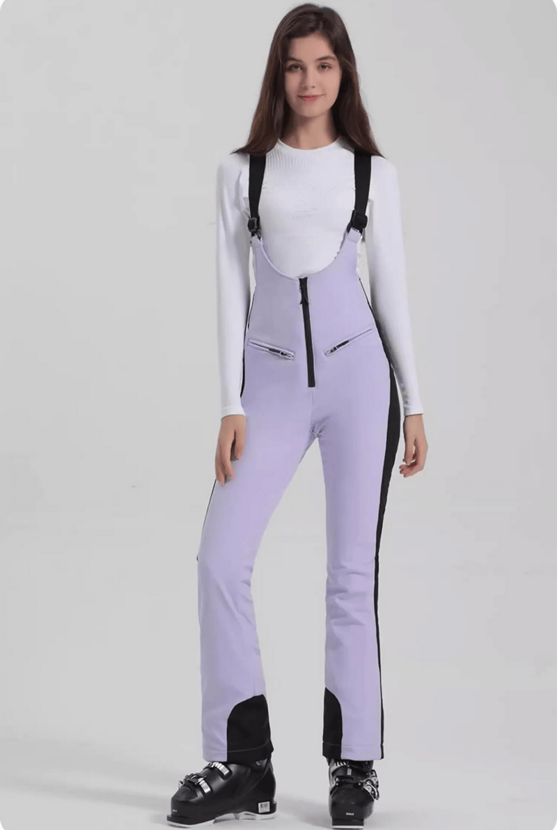Woman wearing windproof waterproof women's thermal ski pants with zipper in lavender, ideal for skiing. Model poses confidently.