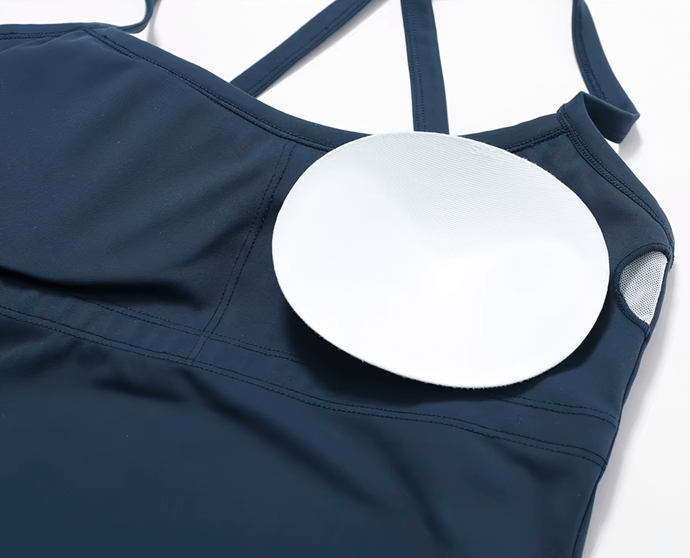 Women's breathable cross-back tank top with removable padding, ideal for fitness and yoga. Stylish design in navy blue.