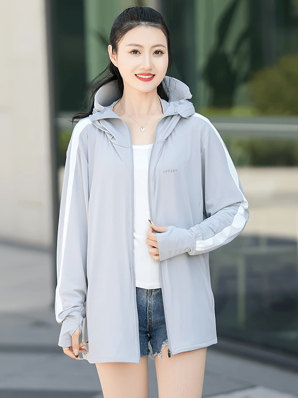 Woman wearing light gray ice silk sun protection windbreaker, ideal for summer sports and casual wear with UPF 50+ protection.