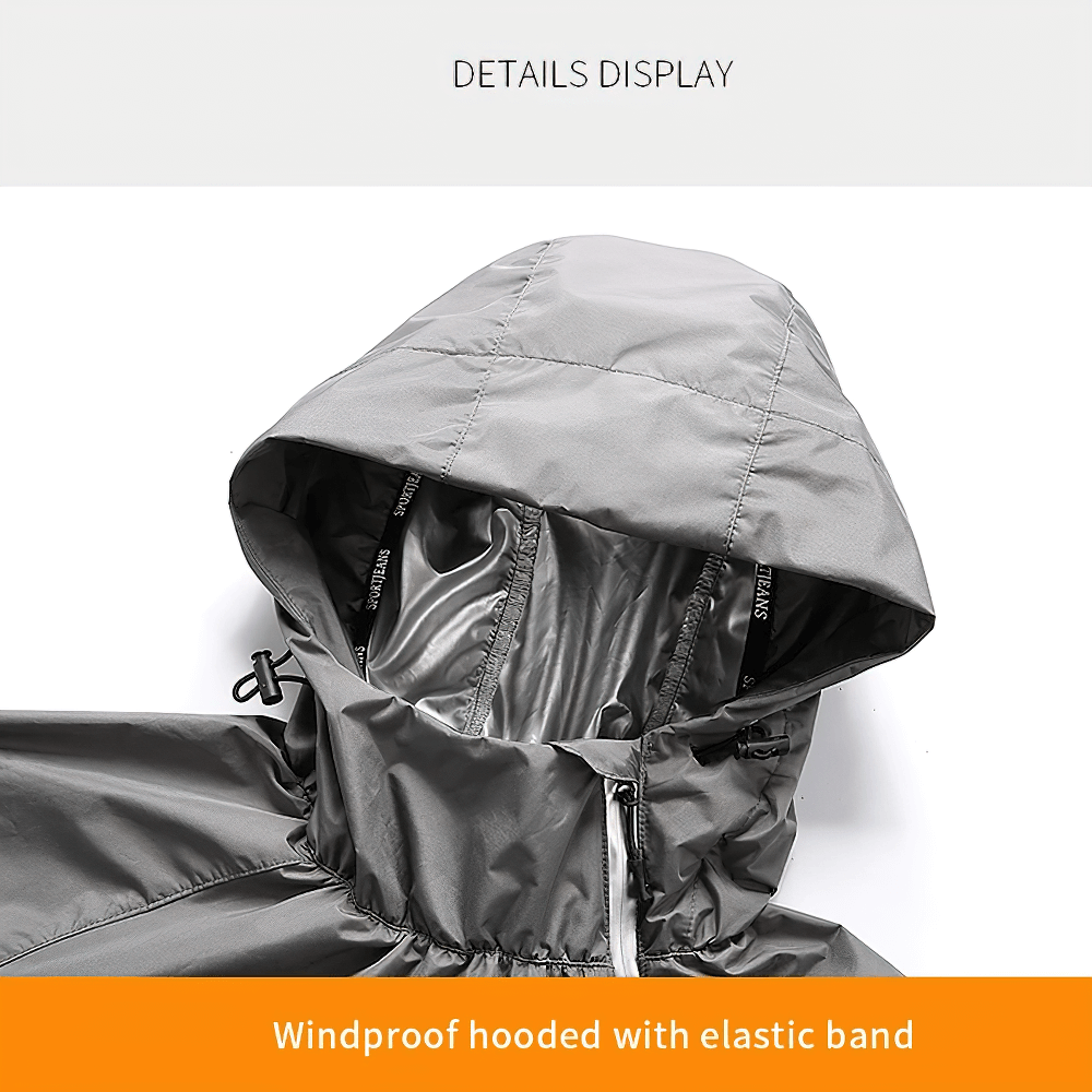 Close-up of windproof hood with elastic band on gray tracksuit, featuring durable fabric and detailed stitching.