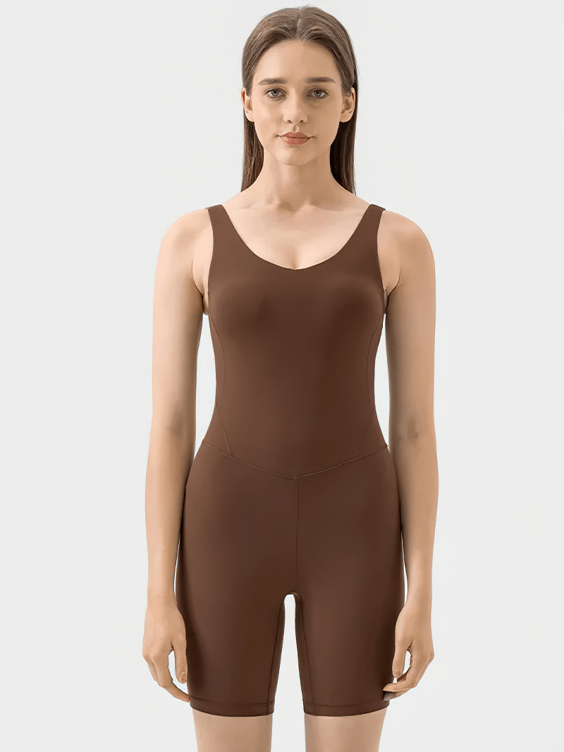 Model wearing women's solid color yoga and pilates bodysuit SF2130, elegant one-piece fitness outfit for style and movement.