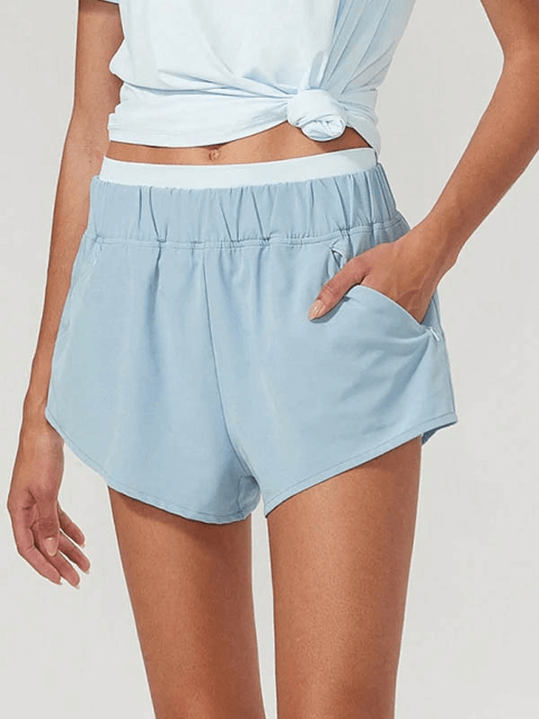 Women's 2-in-1 light blue athletic shorts with side pockets, breathable fabric, perfect for running or workouts.