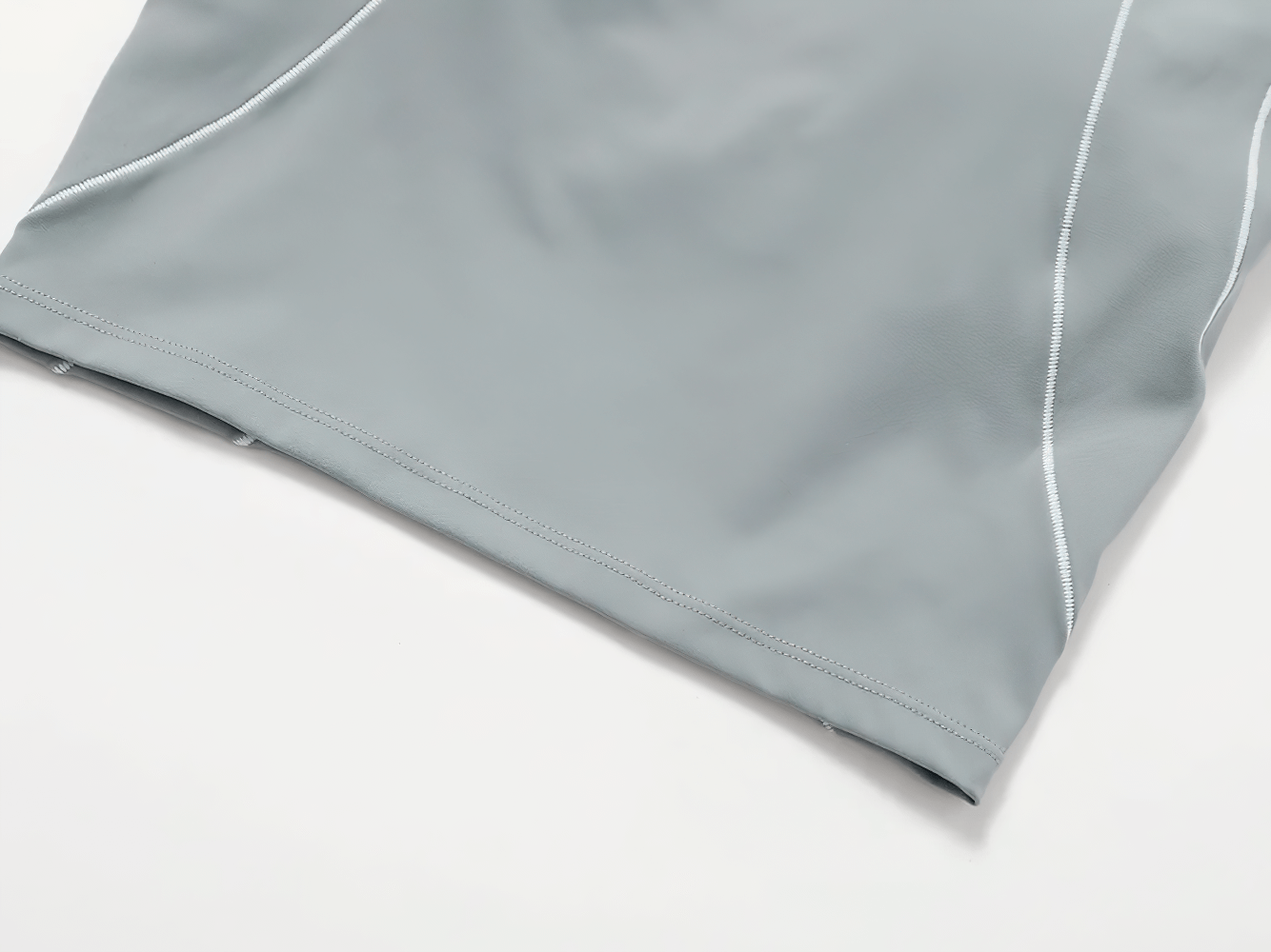 Close-up of women's athletic wear in gray, featuring durable stitching and breathable fabric for gym and running activities.