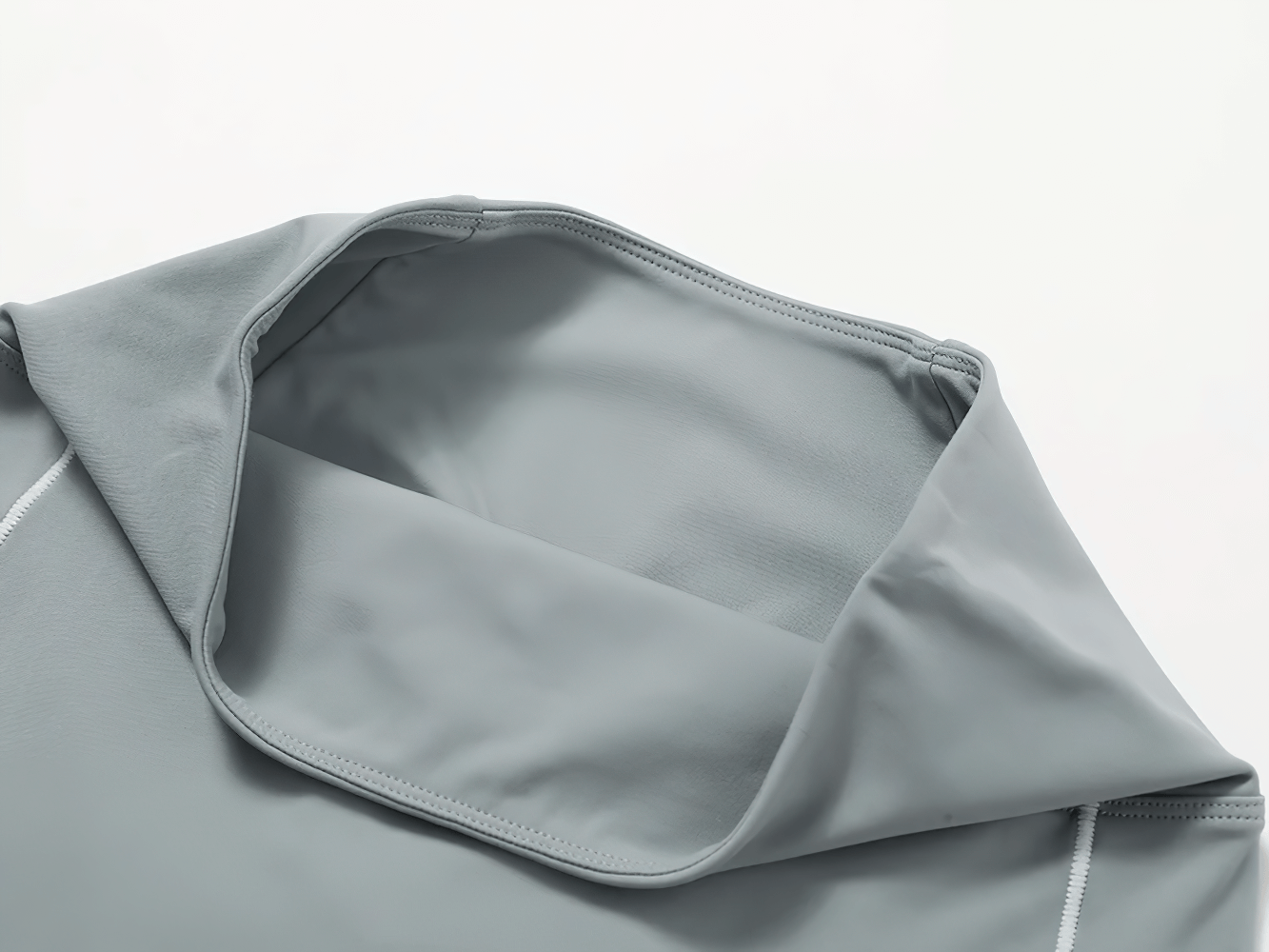 Close-up of breathable grey sportswear fabric with seam details for women's yoga and running.