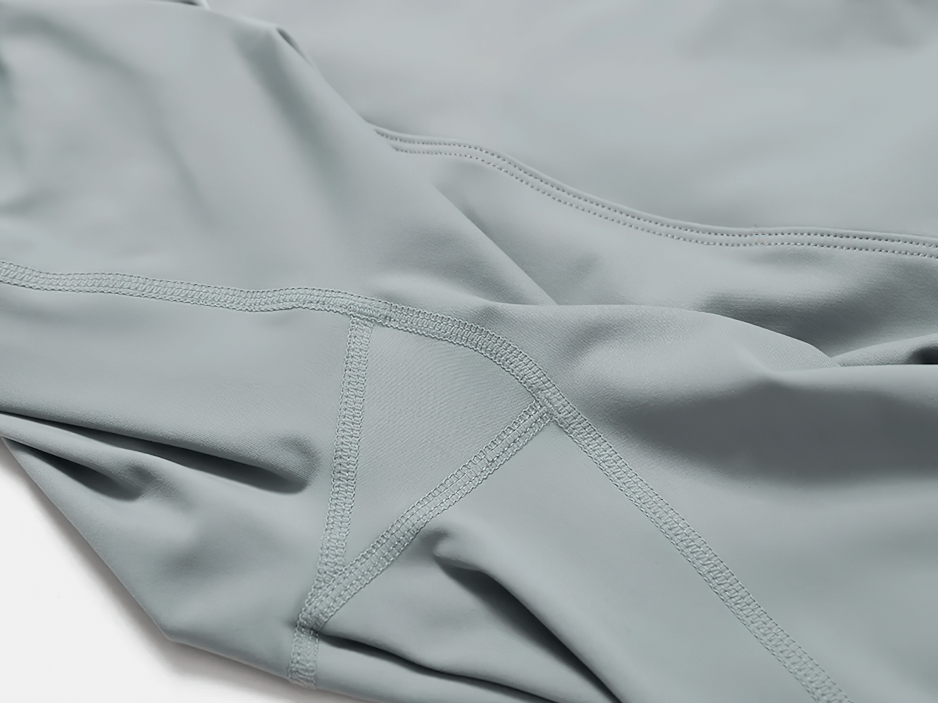 Close-up of breathable women's yoga athletic wear in gray, showcasing high-quality stitching and quick-dry fabric