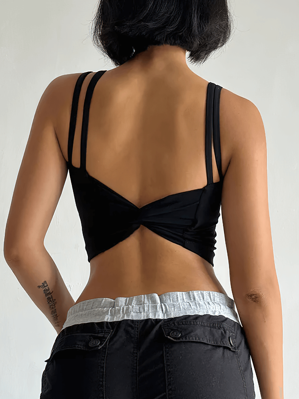Back view of Women's Back-Knot Yoga Sports Bra with Fixed Pads - SF4061, featuring stylish twist-back and sleek design.