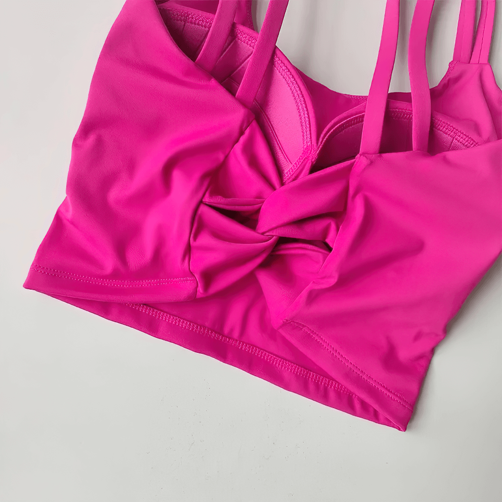 Bright pink Women's Back-Knot Yoga Sports Bra with Fixed Pads - SF4061 showcasing knotted design and sleek fit for fitness activities.