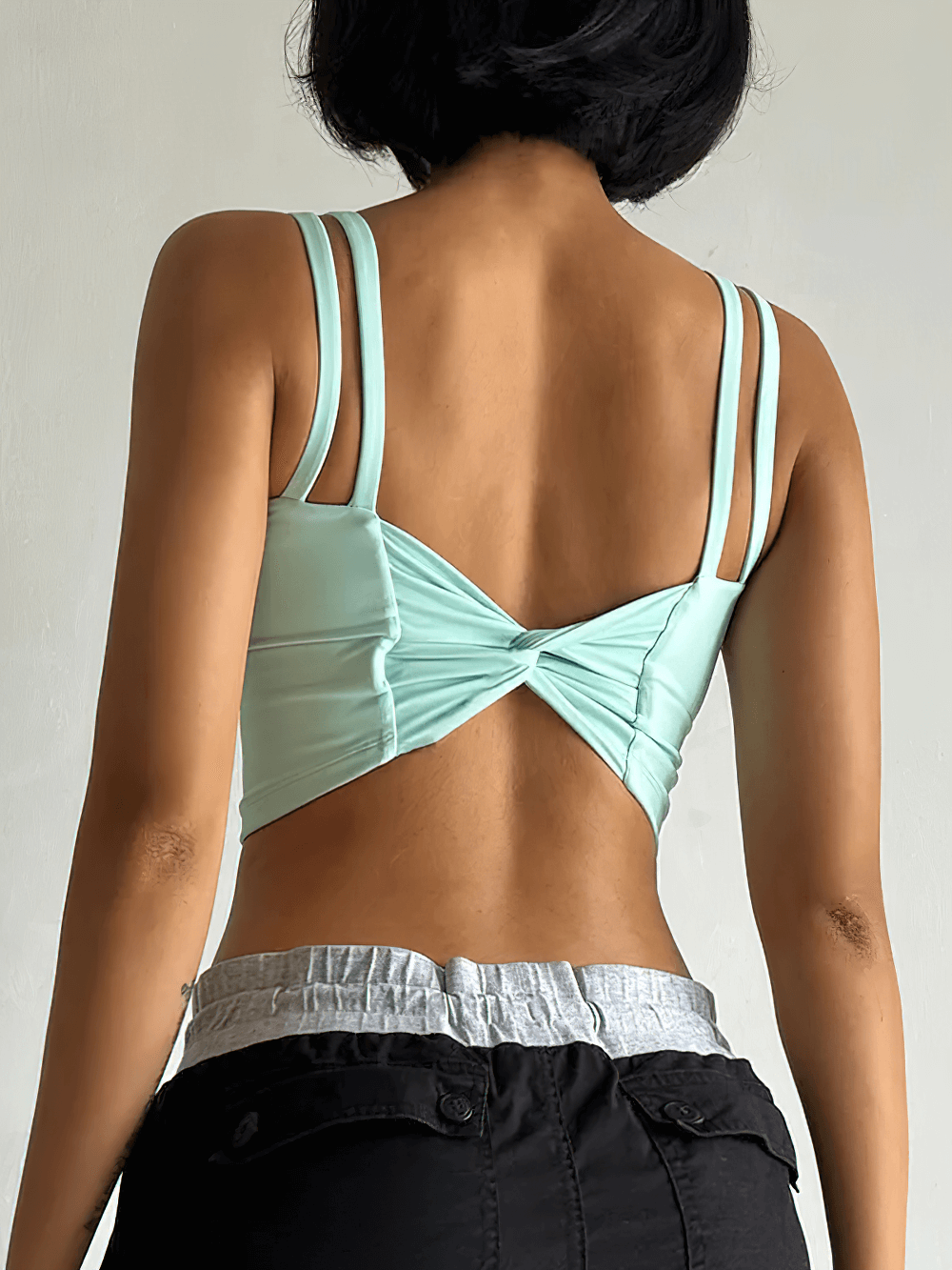 Back view of Women's Back-Knot Yoga Sports Bra with Fixed Pads - SF4061 showcasing knotted design and wide straps.