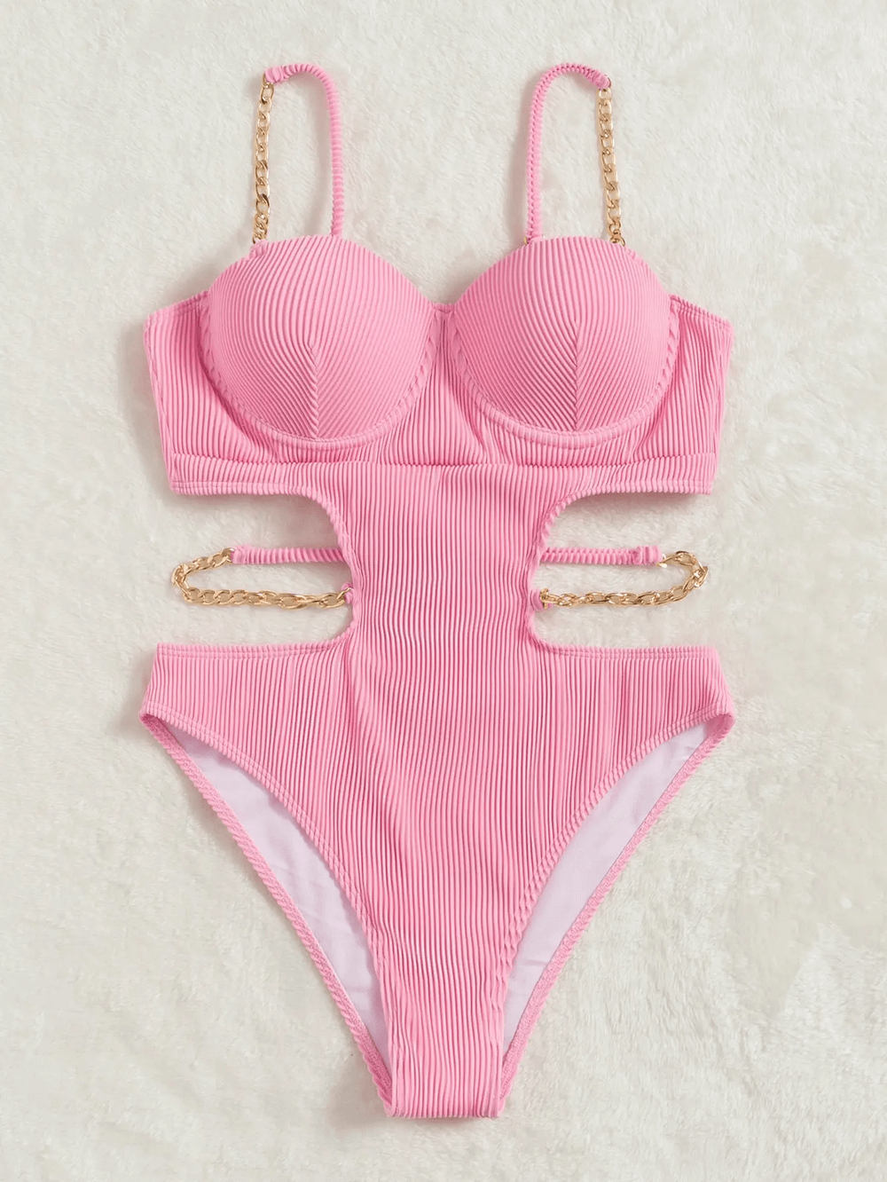 Pink women's backless one-piece swimsuit with chain straps and cutouts, sexy and stylish swimwear for the pool or beach.