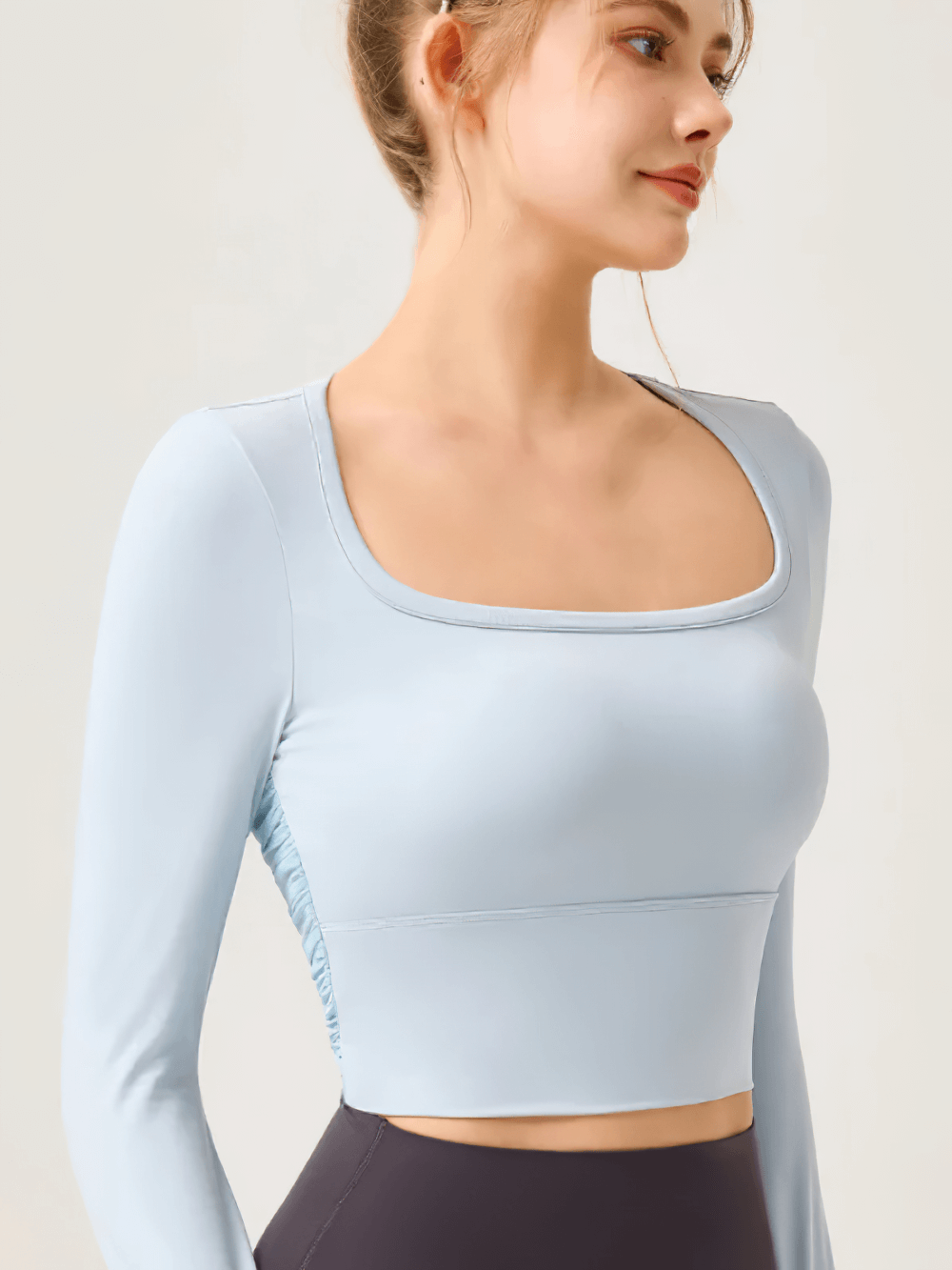 Model wearing Women's Backless Long Sleeve Yoga Top - SF4188, featuring breathable, quick-dry fabric, ideal for yoga and fitness.