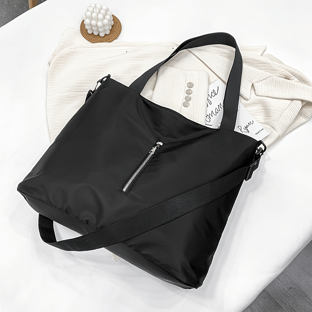 Women's black tote bag SF2664 with adjustable strap, made from durable nylon, perfect for travel and everyday use.