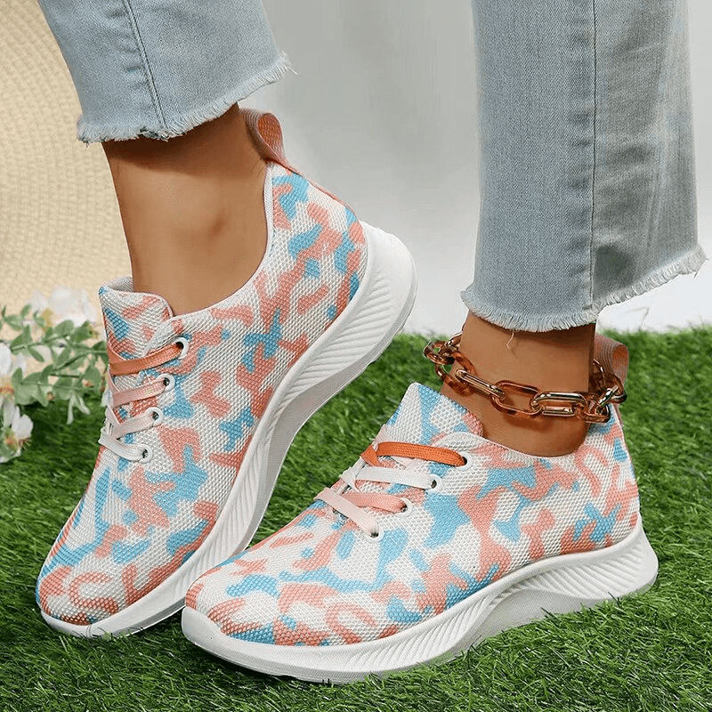 Women's breathable mesh non-slip sports shoes with lace-up, featuring a stylish blue and pink camouflage pattern on grass.