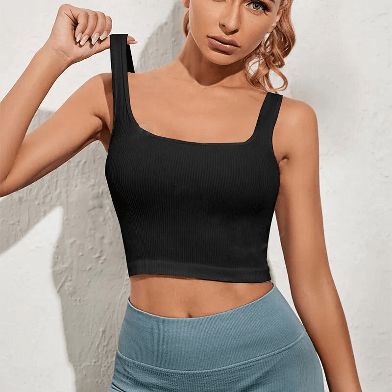 Woman wearing black breathable seamless sports top SF1612, showing its pushup effect and comfortable fit