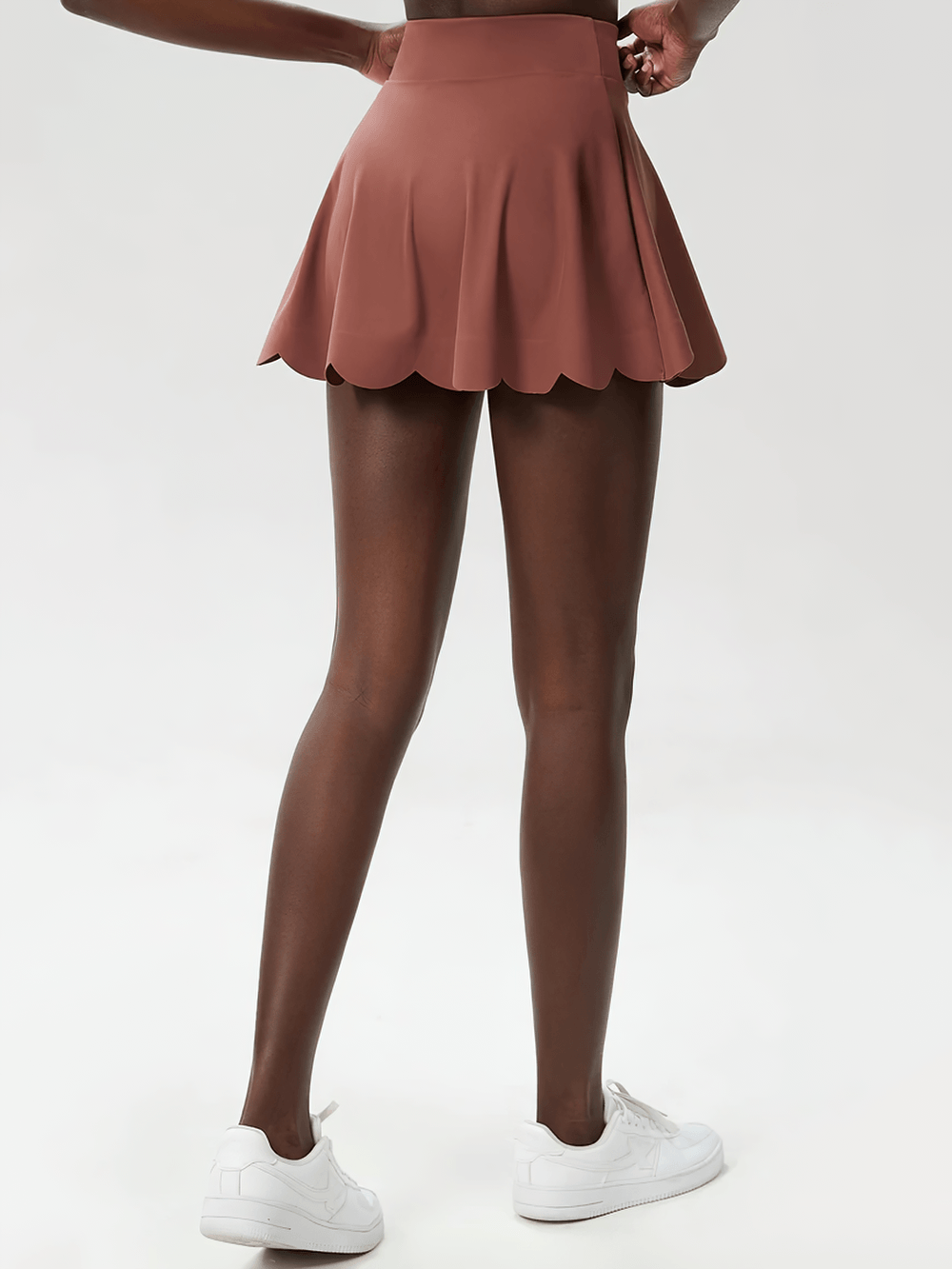 Alt Tag: Women's Breathable Tennis Skirt with Pocket - SF4443 in dusty rose with scalloped hem, back view, worn with white sneakers