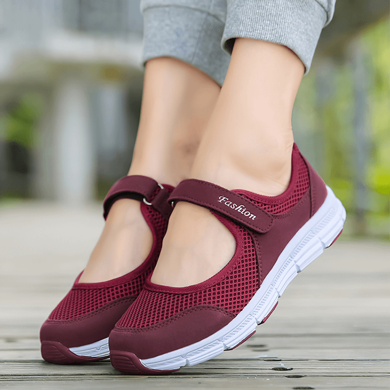 Women's breathable vulcanized flat shoes in maroon with air mesh and hook loop closure, perfect for lightweight comfort and style.