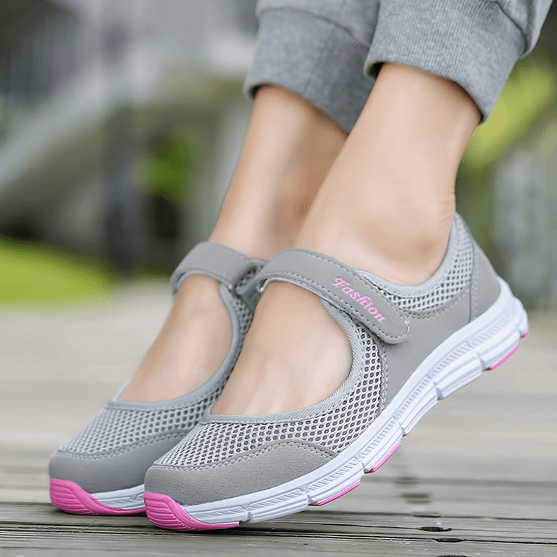 Alt Tag: Women's breathable vulcanized mesh sneakers, grey with pink accents, hook and loop closure, flat heel, perfect for style and comfort.