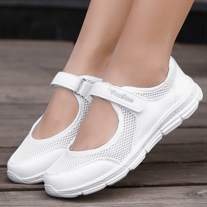 Women's breathable white vulcanized flat shoes with air mesh and hook and loop closure for stylish comfort.