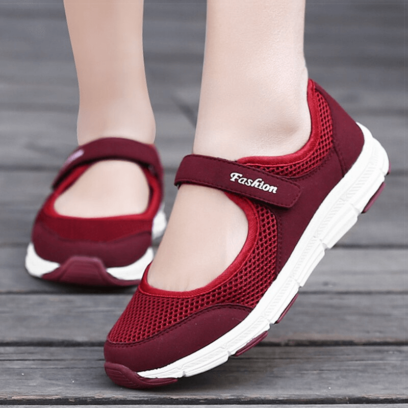 Women's breathable vulcanized flat shoes in red, featuring air mesh upper and hook and loop closure for a stylish and comfy fit.