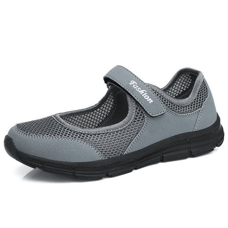 Women's breathable gray mesh sneakers with hook and loop closure, offering lightweight comfort and a stylish flat sole design.