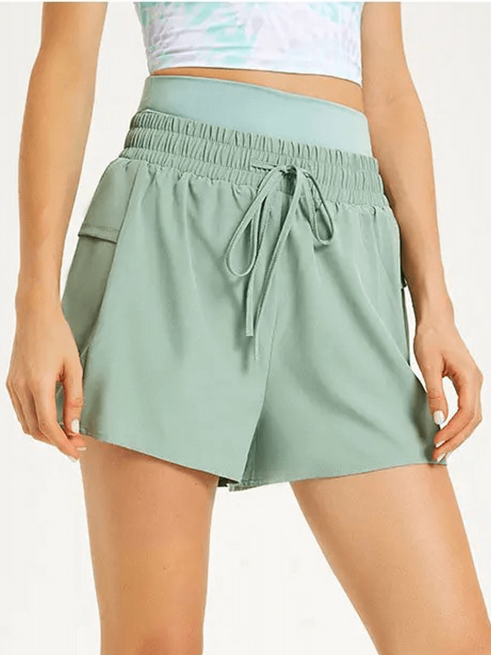 Green women's casual drawstring athletic shorts SF2233 for summer, made of polyester-spandex blend, shown worn by model, stylish for sports.