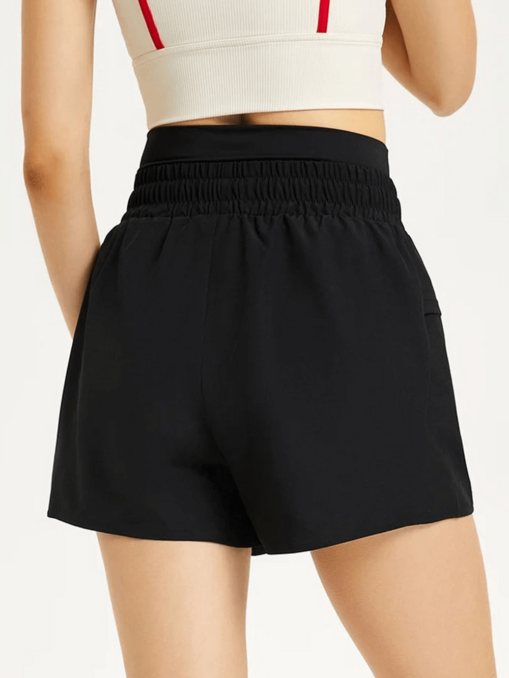 Woman wearing black casual drawstring athletic shorts, perfect for summer sports, shown from the back.