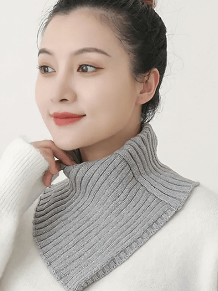 Woman wearing a cozy gray chunky knit cotton snood scarf, perfect for outdoor winter warmth and style, showcasing a solid ring pattern.