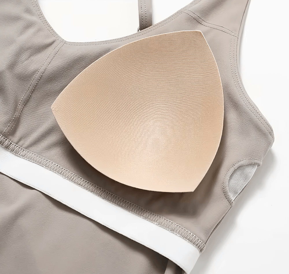 Close-up of a women's cross-back adjustable yoga tank top with a removable foam pad, showcasing its quality design and materials.