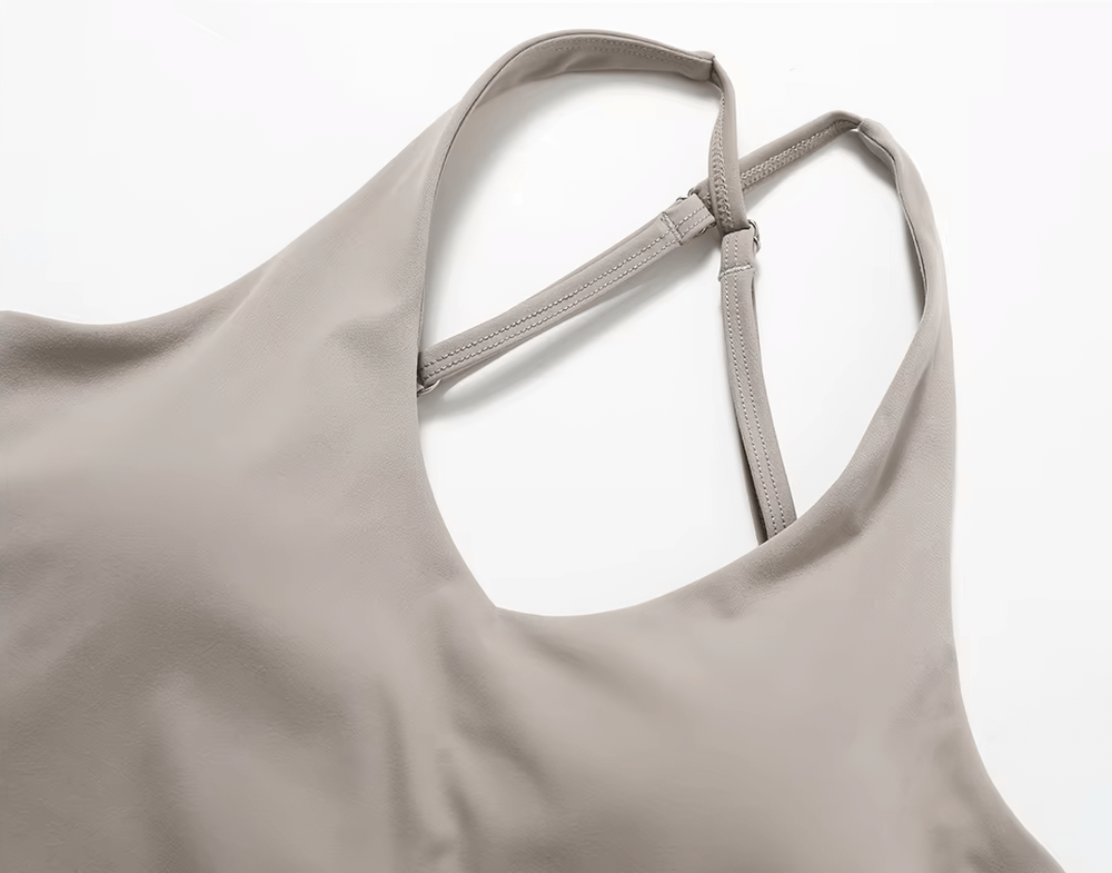 Women's cross-back adjustable yoga tank top in gray, featuring breathable nylon and spandex fabric for active workouts and stylish support.