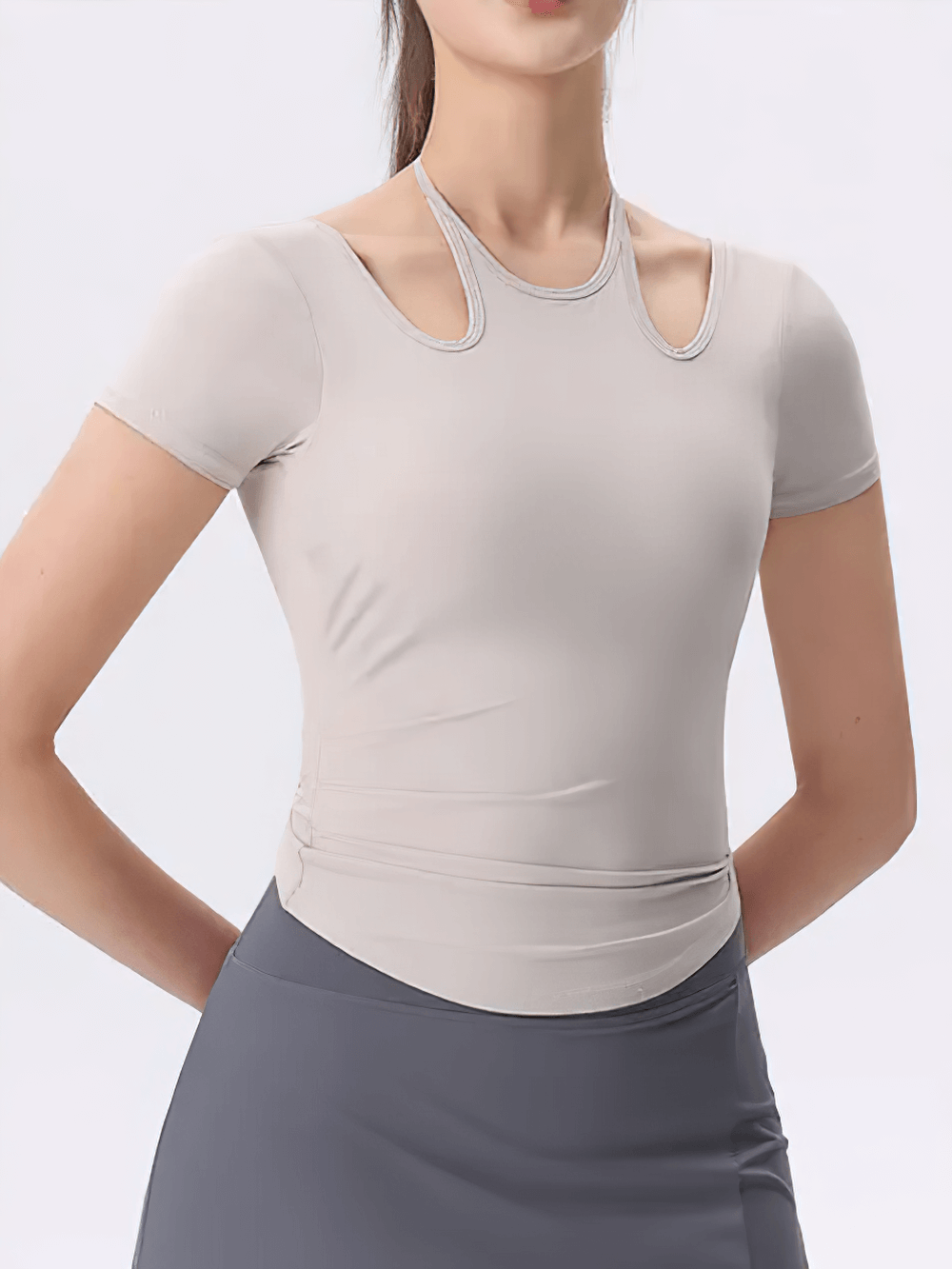 Woman wearing elastic cross-back athletic yoga t-shirt SF2108 with unique neckline, designed for optimal movement and workouts.