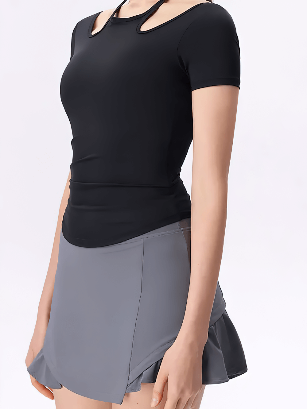 Women's cross-back athletic yoga t-shirt with unique neckline, perfect for active lifestyles and versatile workouts, model in black top.