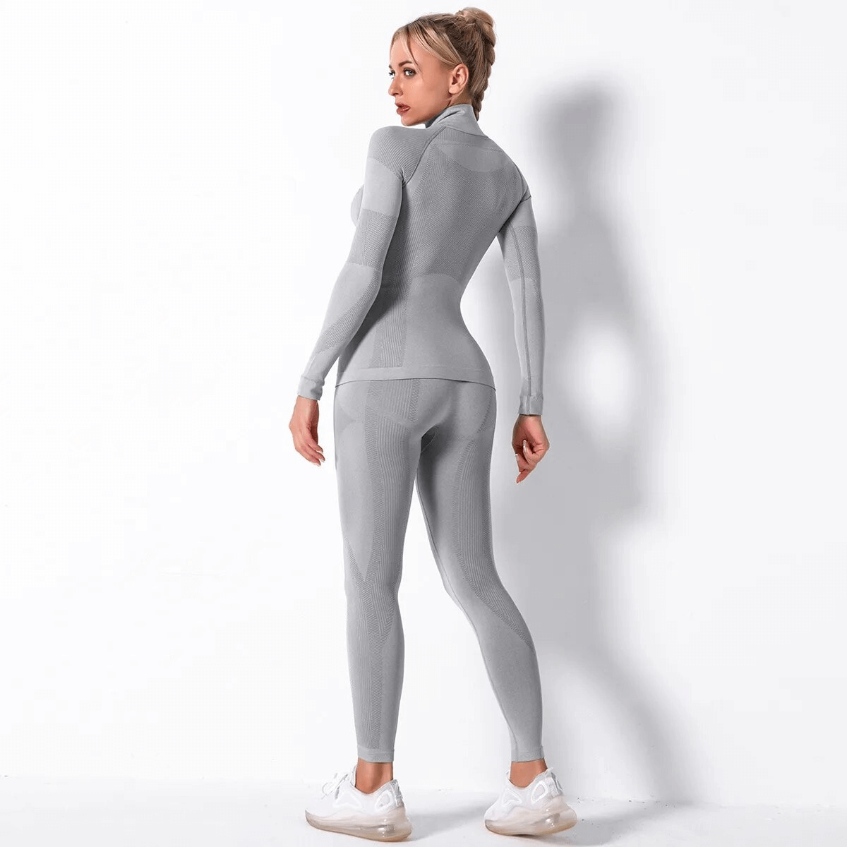 Women's grey elastic leggings and long sleeves top set for yoga, SF1755, made from breathable polyester, shown on standing model.