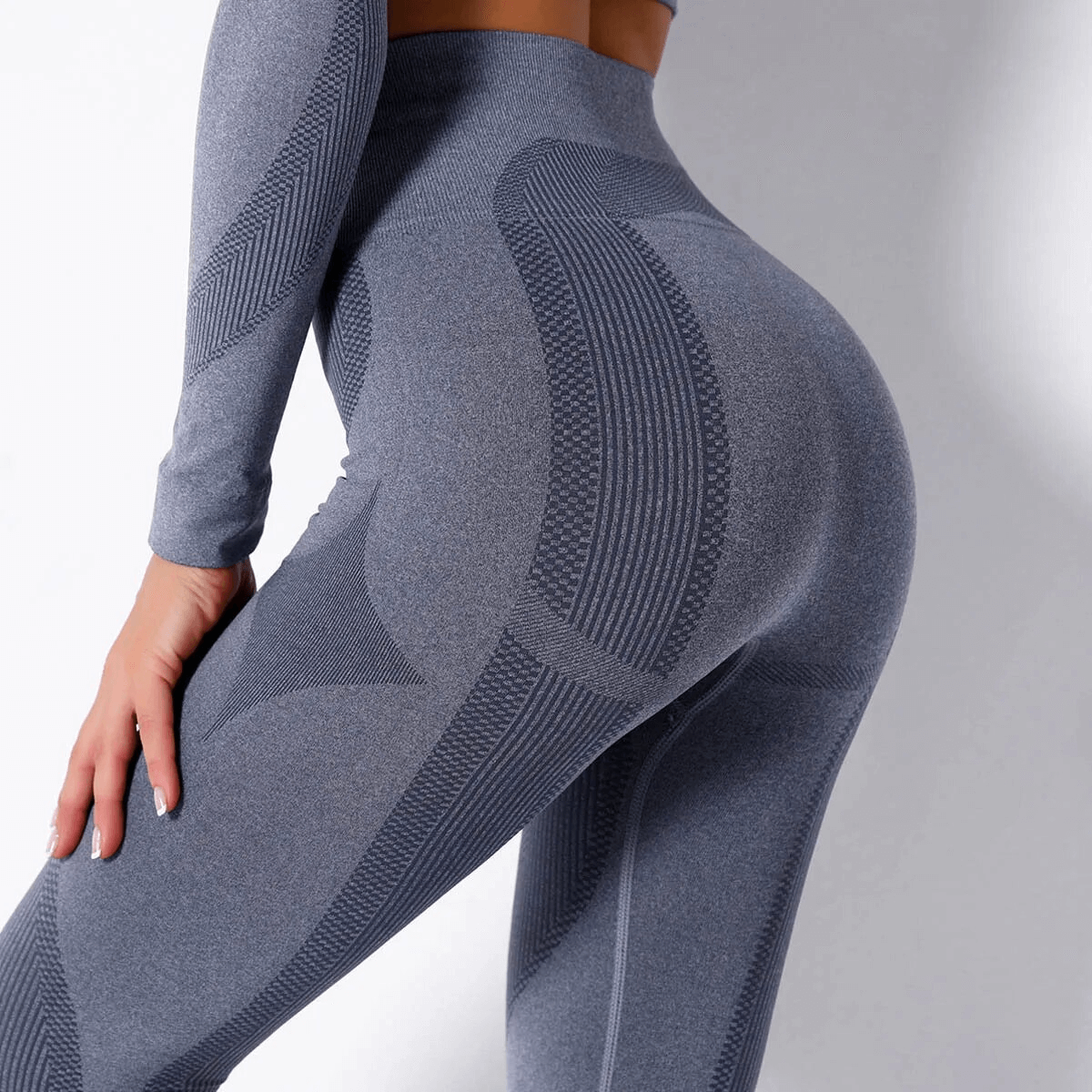 Women's yoga leggings and long sleeve top set in gray, showcasing sleek design and comfortable fit.