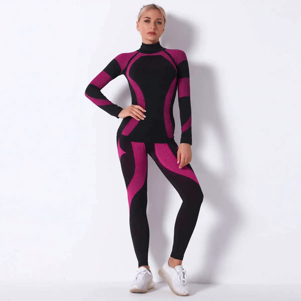 Women's pink and black elastic leggings and long sleeve top set for yoga, showcasing modern design and quick-drying polyester material.