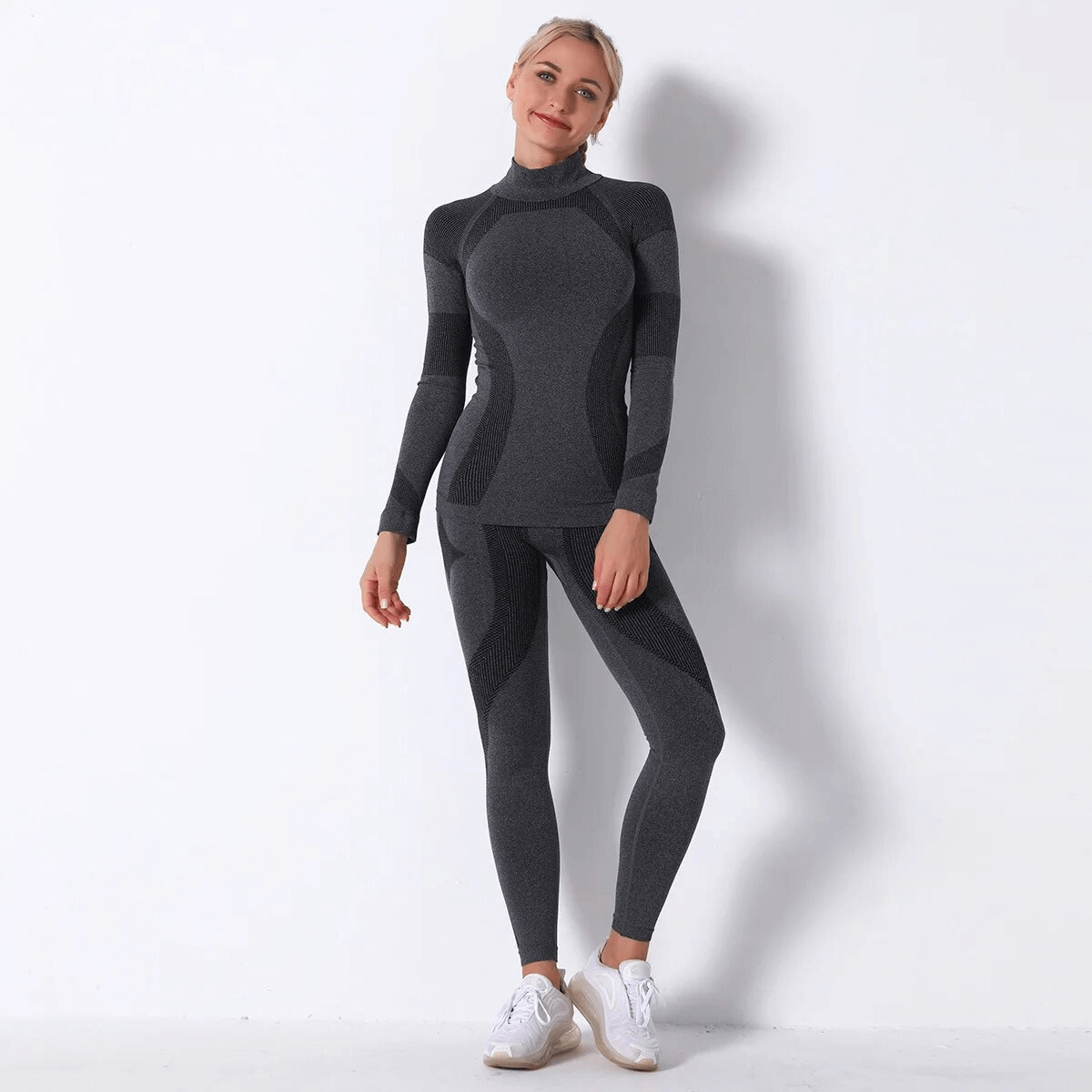 Woman wearing SF1755 elastic leggings and long-sleeve yoga top in gray, perfect for active modern yogis.