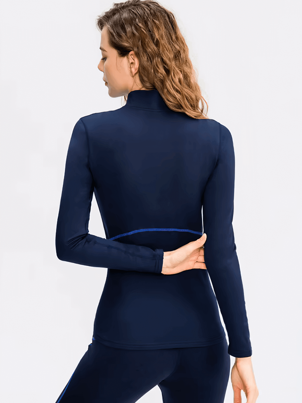 Women's navy long-sleeve thermal base layer, ideal for winter sports like skiing and biking. Elegant design for warmth and comfort.