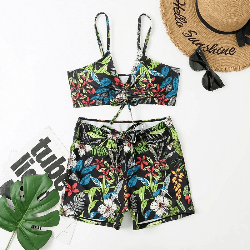 Women's flower print two-piece bathing suit in vibrant floral design, featuring top and shorts for elegant swimming comfort.