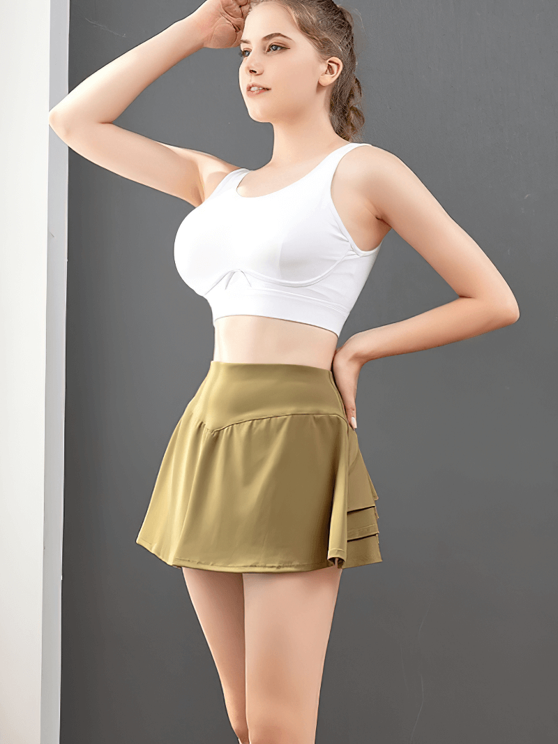 Stylish women's pleated golf tennis skort with inside pocket in olive, designed for comfort and mobility with breathable fabric.