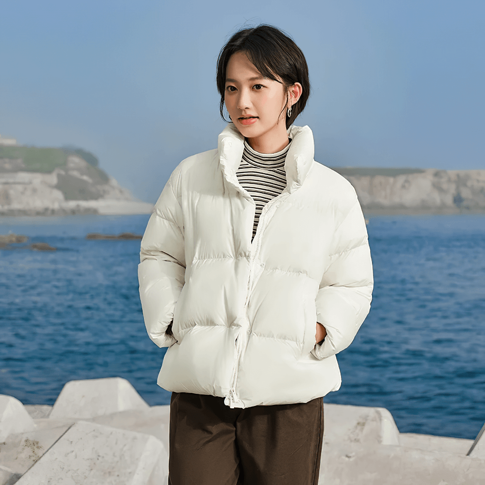 Women's goose down jacket with stand-up collar, casual style, solid color, perfect for winter warmth by the sea.