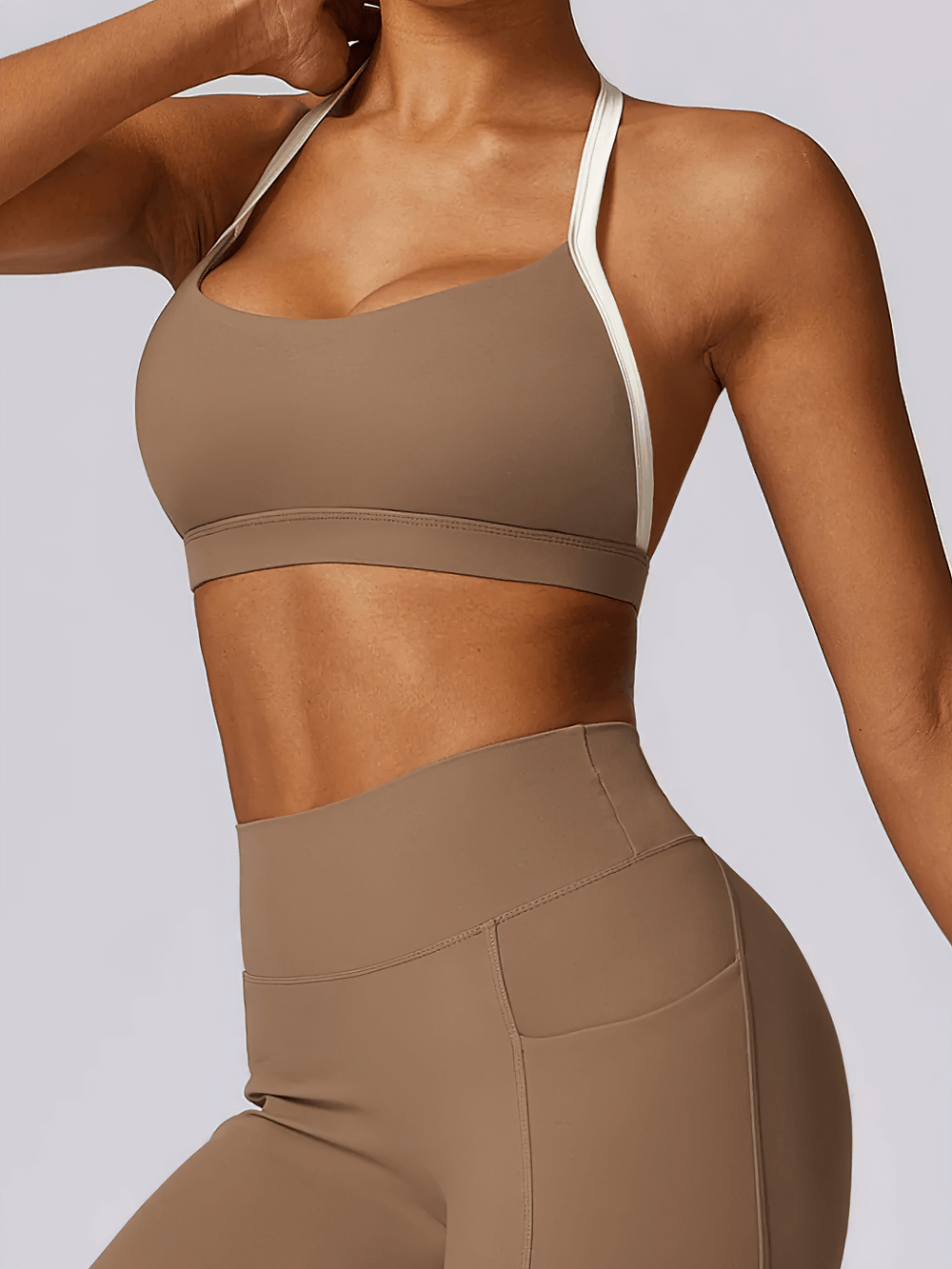 Stylish women's halter sports bra with contrast trim, perfect for yoga and light workouts. Modern design with open-back for breathability.