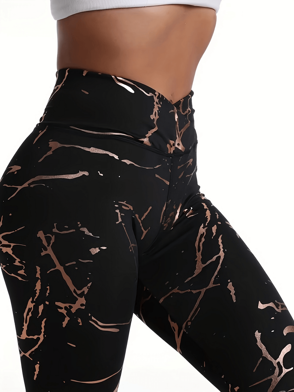 Women's high-waist abstract print leggings, bold black and tan design, stretchy polyester blend, perfect for workouts or yoga.