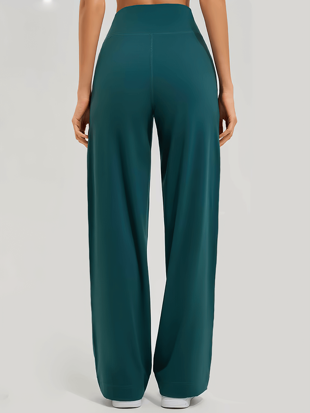 Back view of high-waist flared yoga pants with pockets in teal, showcasing loose fit and full-length design perfect for workouts.