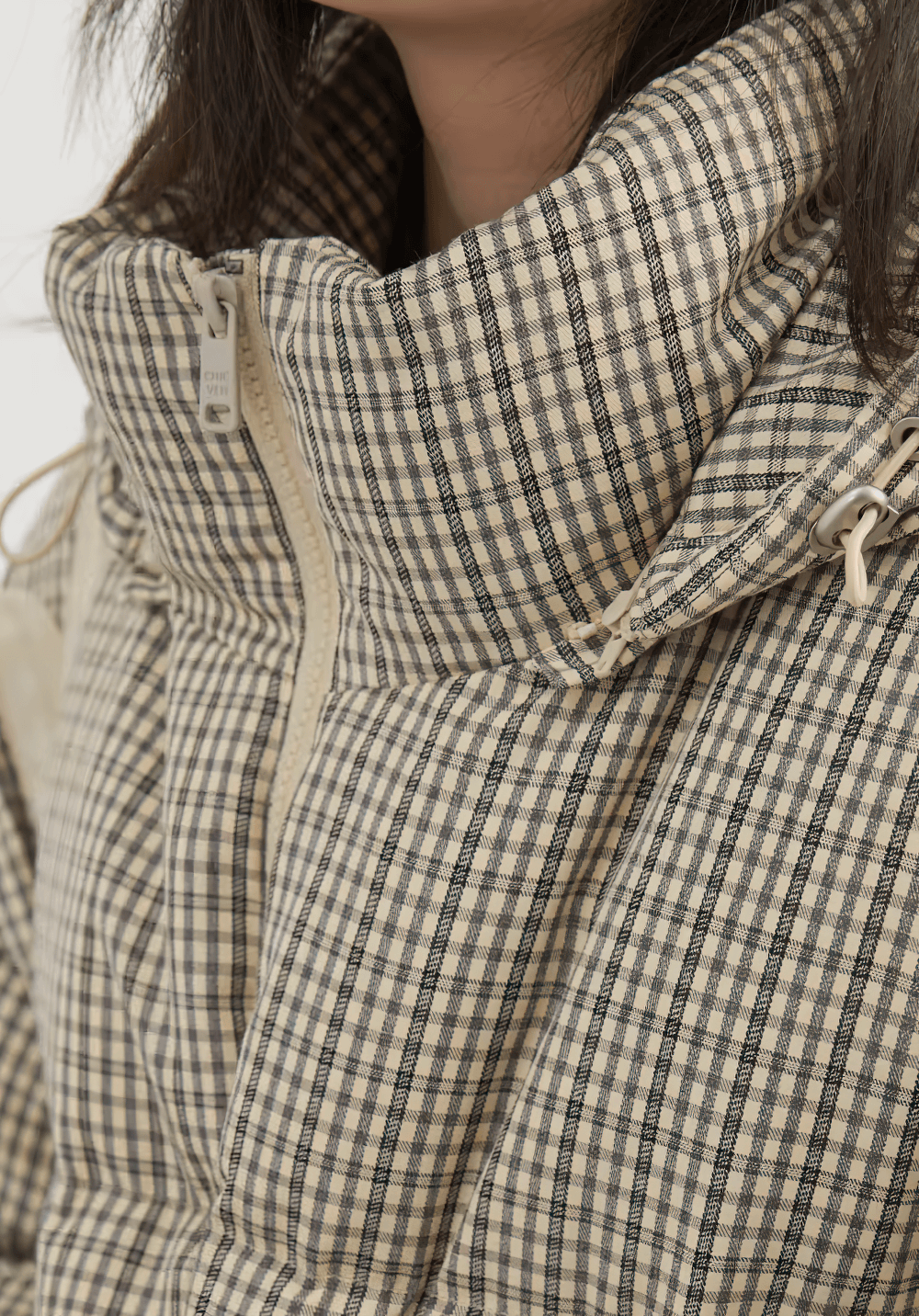 Close-up of women's hooded plaid down jacket SF2308 with zipper closure, featuring a chic winter-ready design.