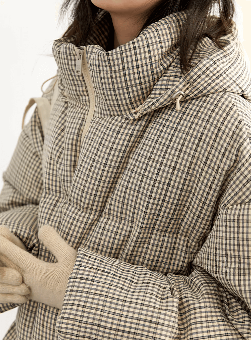 Women wearing hooded plaid down jacket with duck down, featuring zipper closure and full sleeves for winter warmth.