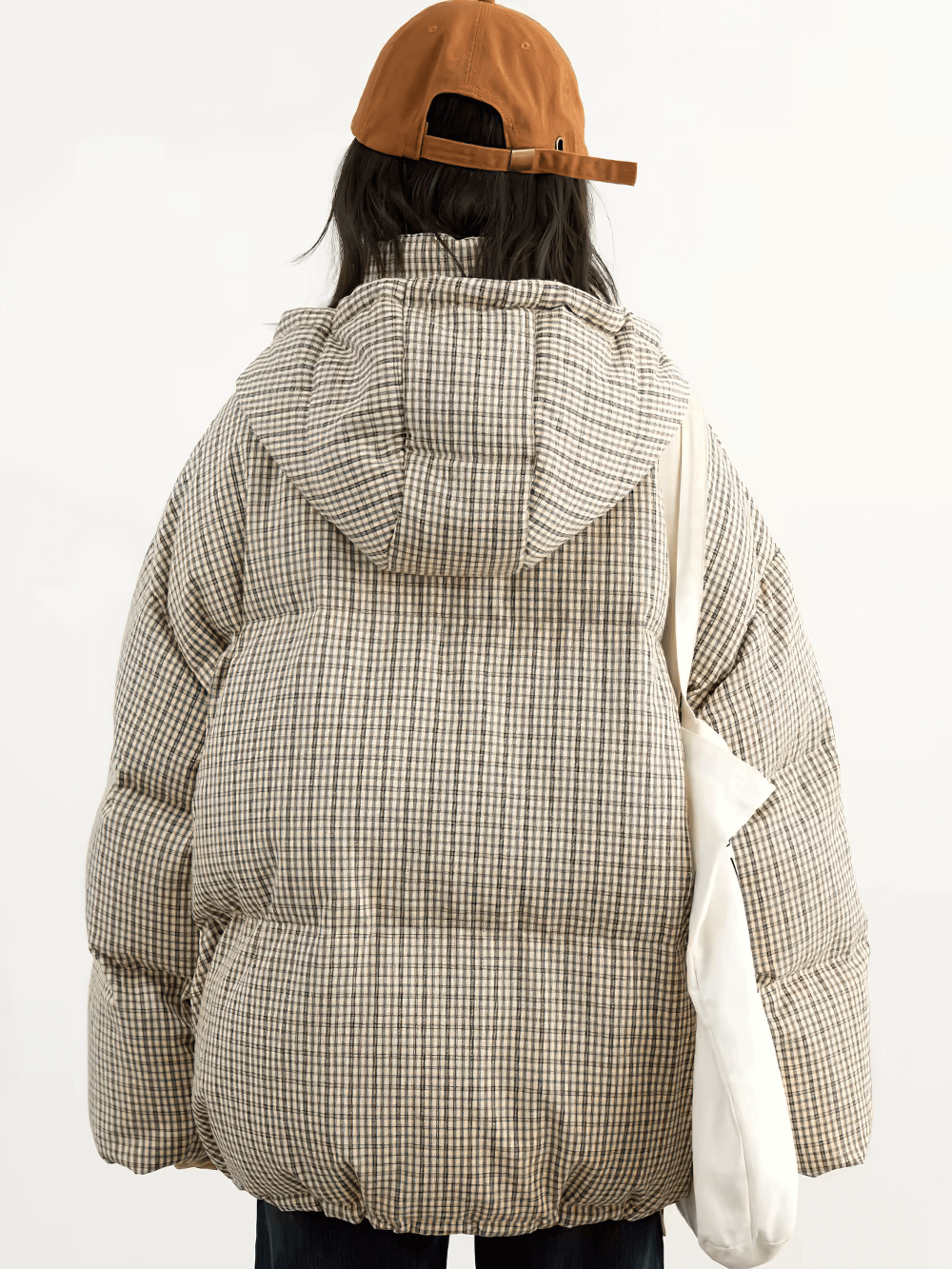 Back view of a chic women's hooded plaid down jacket with duck down, showcasing its cozy, oversized fit and warm winter style.