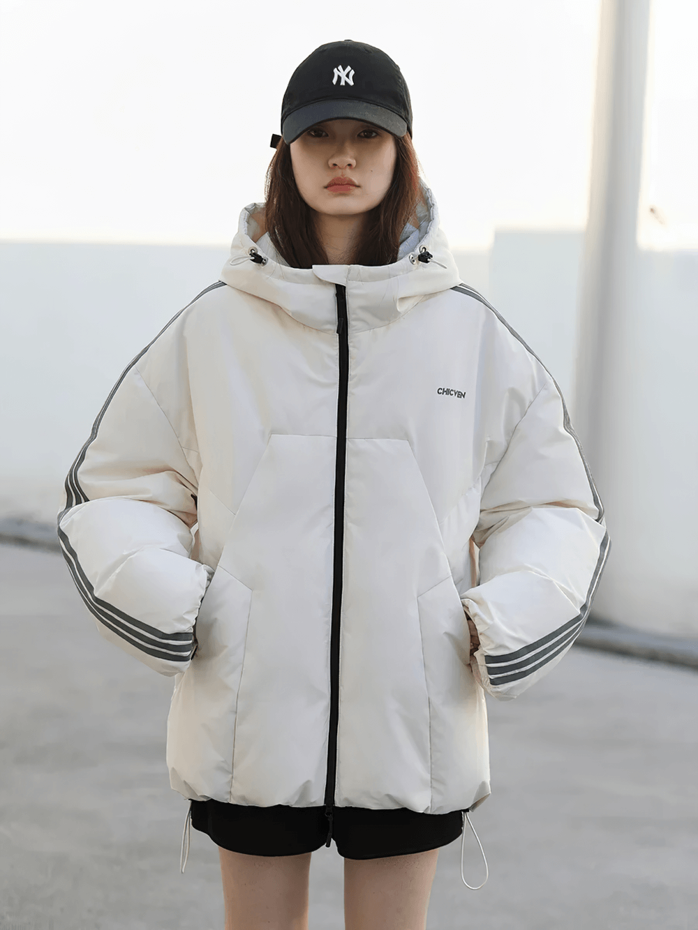 Model wearing women's hooded striped duck down winter jacket - SF2311, casual streetwear vibe with loose fit and full sleeves.